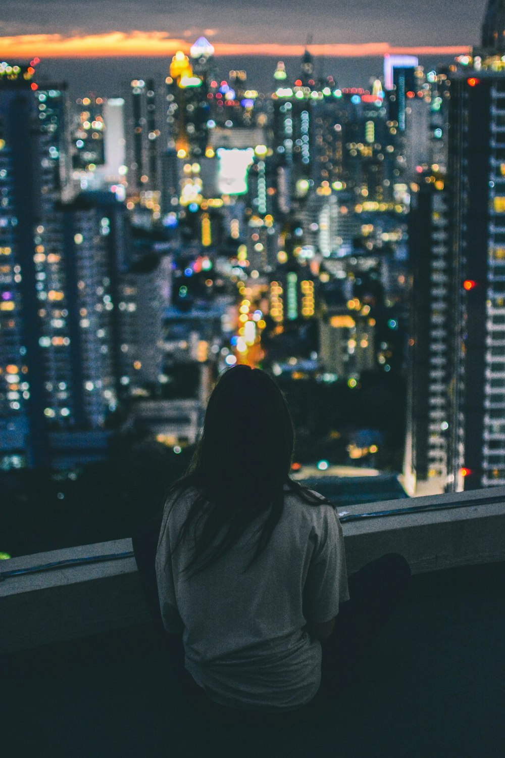 woman in gray top on top of the building