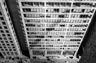 View of the office building from street level with people walking by.