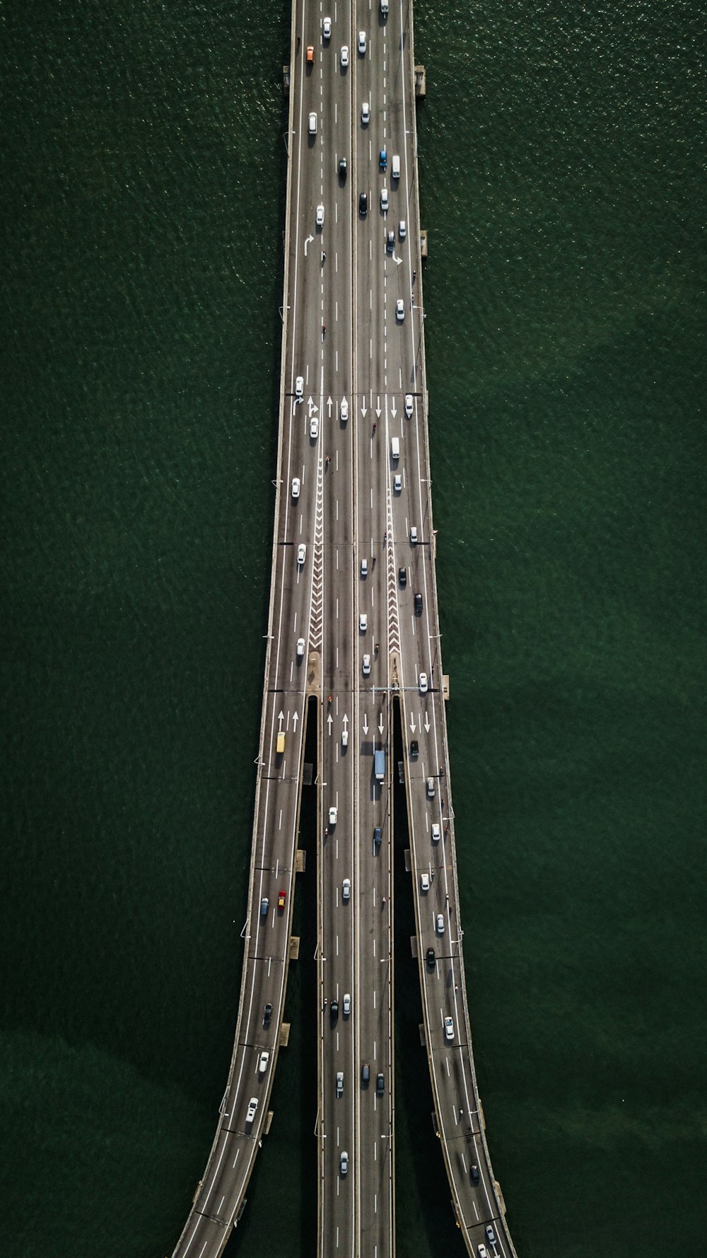 aerial view of bridge with cars crossing