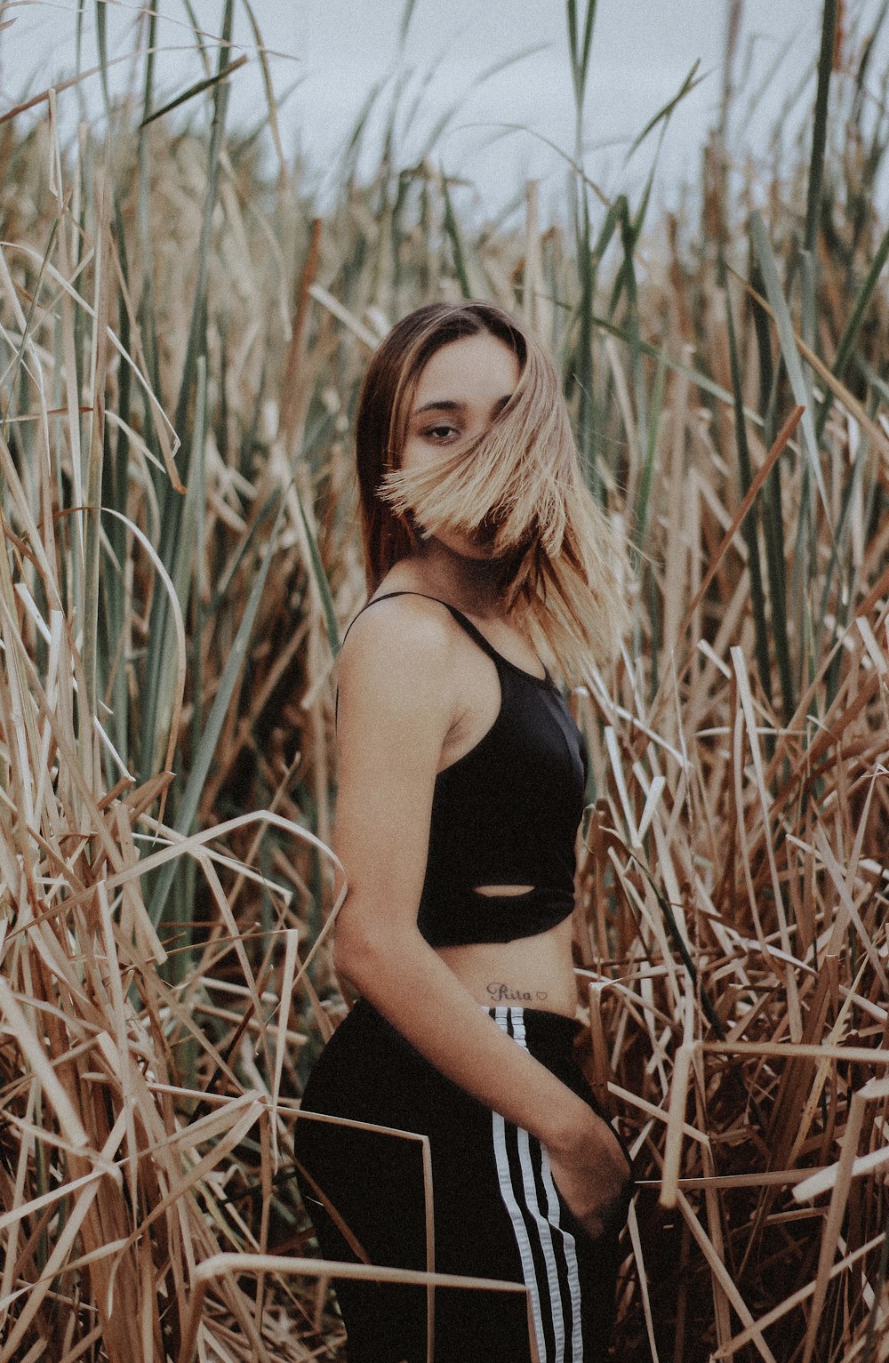 woman at grass flipping her hair