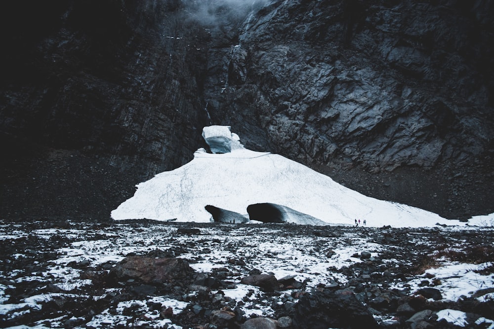 landscape photo of ice near gray cliff