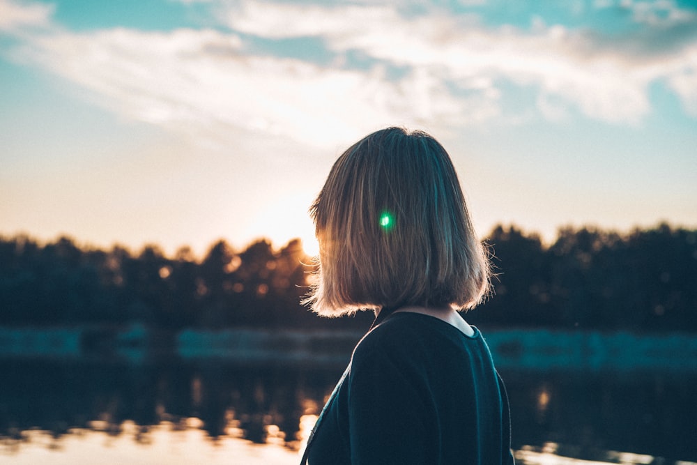 woman standing near lake during daytime