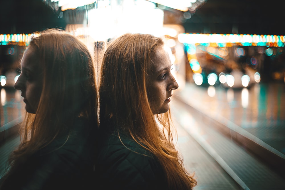 reflection of woman leaning against wall