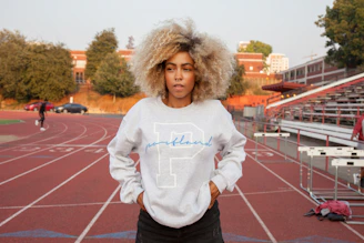 Monie training intensely on a track at sunrise, embodying focus and determination.