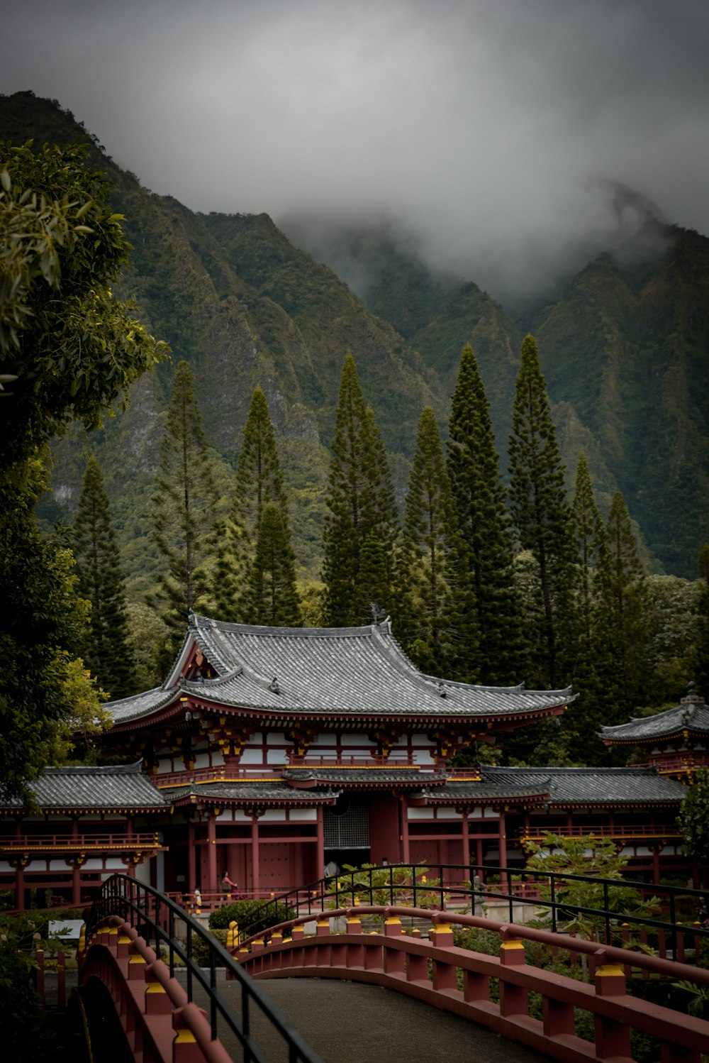 temple with bridge near mountain range