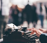 person using black typewriter