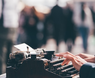 person using black typewriter