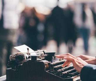 person using black typewriter