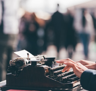 person using black typewriter