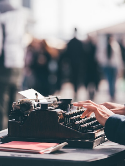 person using black typewriter