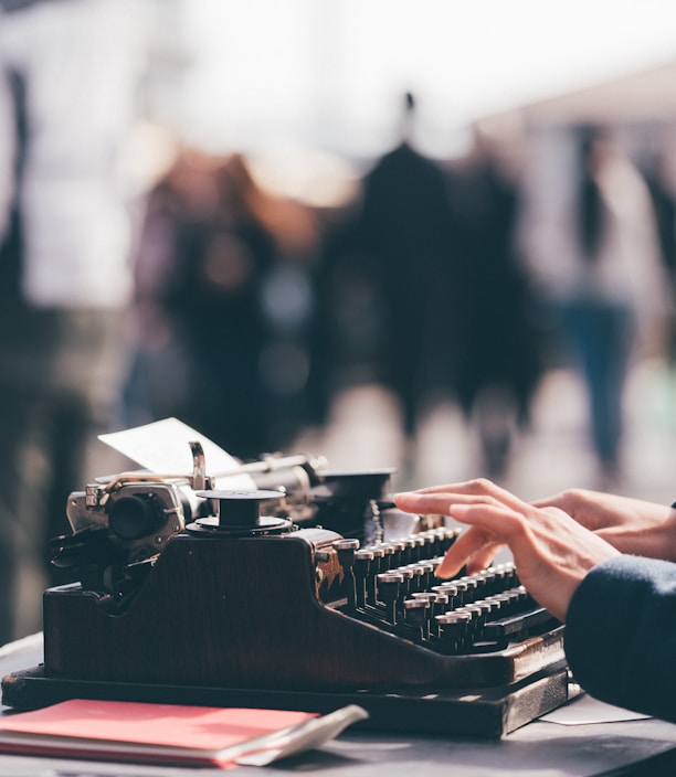 person using black typewriter