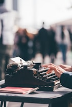 person using black typewriter