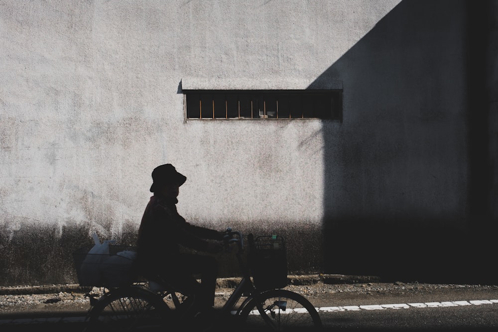 silhouette of man riding bicycle