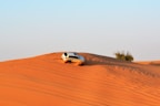 white SUV on desert during daytime photo