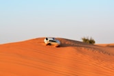 white SUV on desert during daytime photo