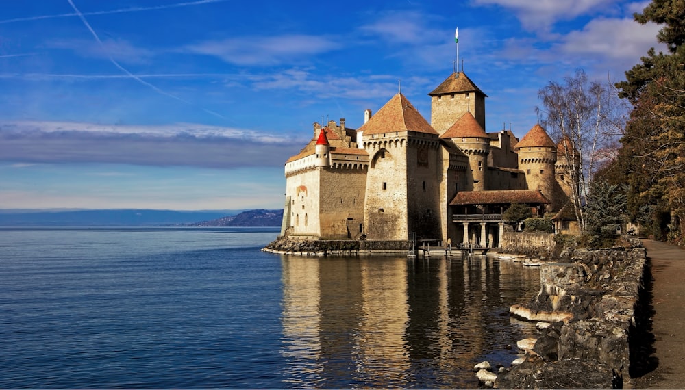 castle by the sea under blue sky