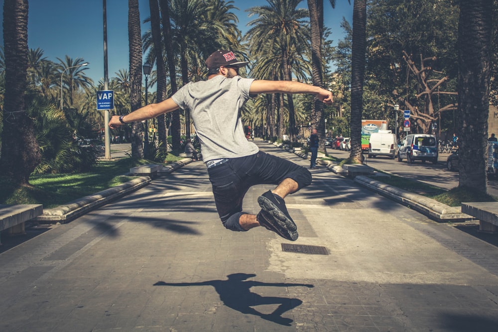 man jumping in the middle of road