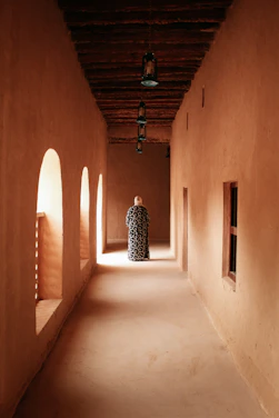 person wearing black and white dress walking on the halway