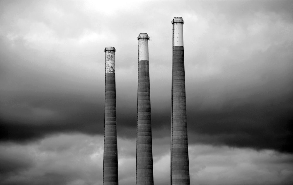 grayscale photo of three different height lighthouses