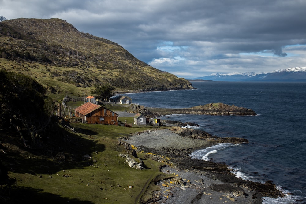 aerial photography of brown wooden house near seashore