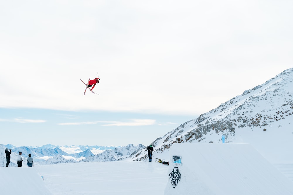 person hovering over snow covered ground during daytime