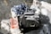 A pebbled shoreline with a black and gray backpack, a checkered shirt, and a book titled 'The Subtle Art of Not Giving a F*ck' by Mark Manson on top of a large rock.