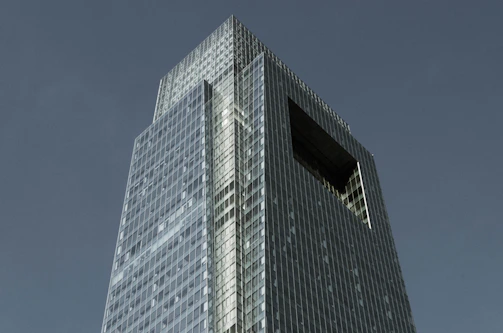 Exterior view of the flagship property showcasing modern architecture against a clear blue sky.