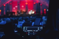 a stage with a laptop and microphone in front of a crowd