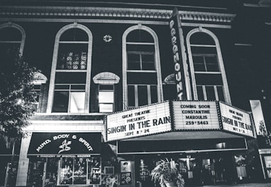 grayscale photo of theater hall with Singin in the Rain movie