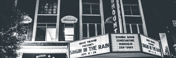 grayscale photo of theater hall with Singin in the Rain movie
