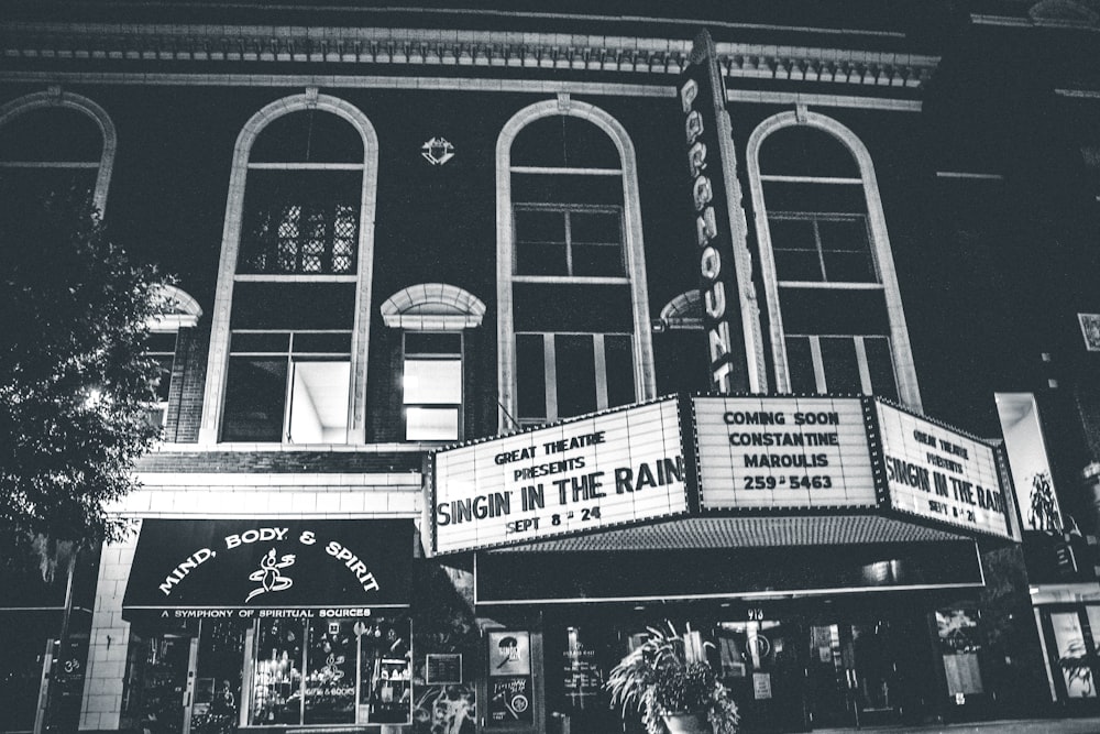 grayscale photo of theater hall with Singin in the Rain movie