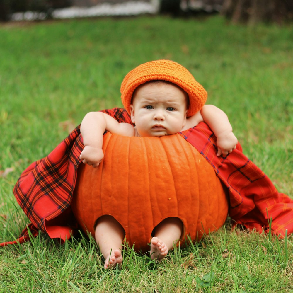 baby in red pumpkin