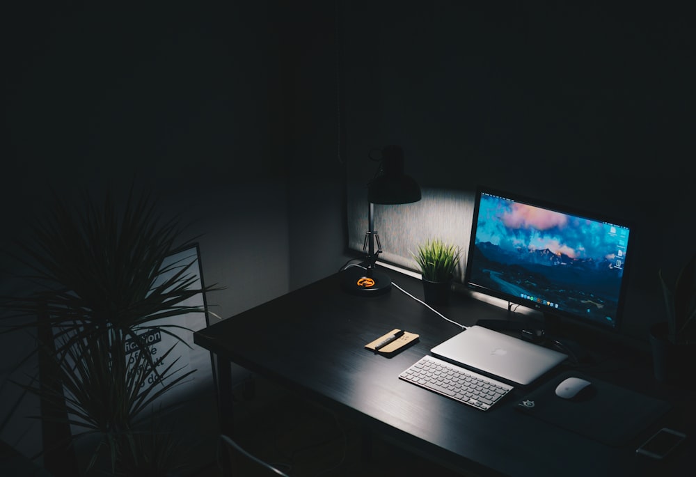 a desk with a computer monitor and keyboard on it