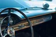 Close-up of a polished vintage car dashboard with mid-century modern design elements.