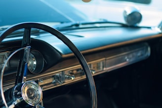 A close-up of a vintage 1955 Chrysler dashboard showcasing classic design elements.
