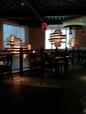 Contemporary restaurant setting featuring elegant pendant lights creating an inviting atmosphere.