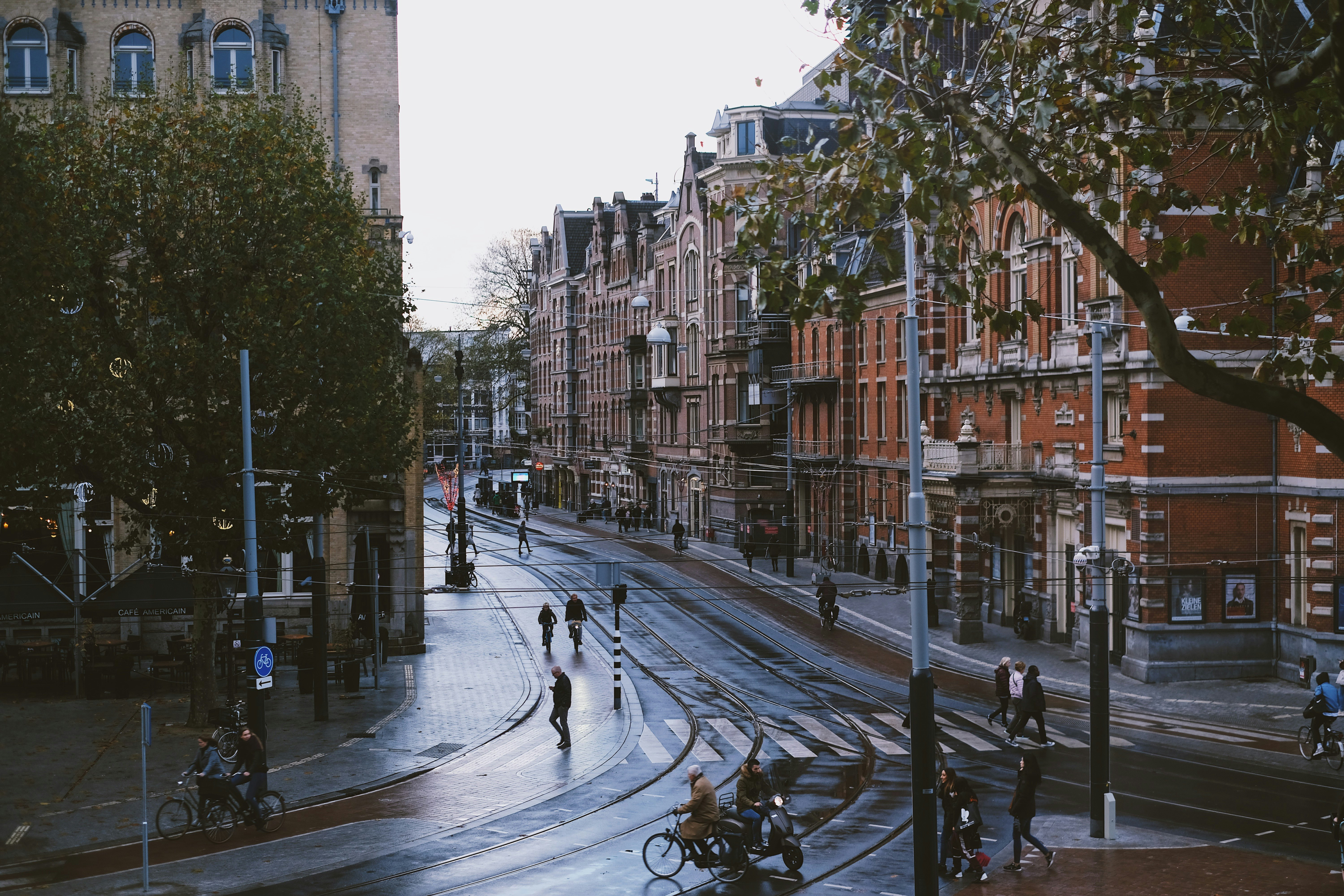 people walking on road near brown buildings during daytime