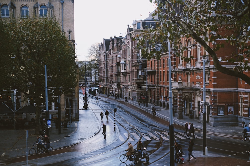 people walking on road near brown buildings during daytime