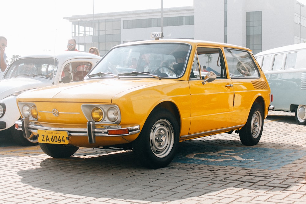 yellow station wagon on concrete floor during daytime