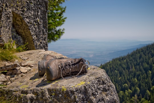 pair of brown leather boots on gray cliff in Kominite Bulgaria