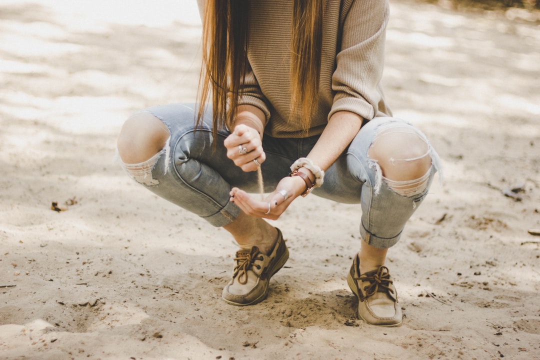 woman pouring sand in her other hand