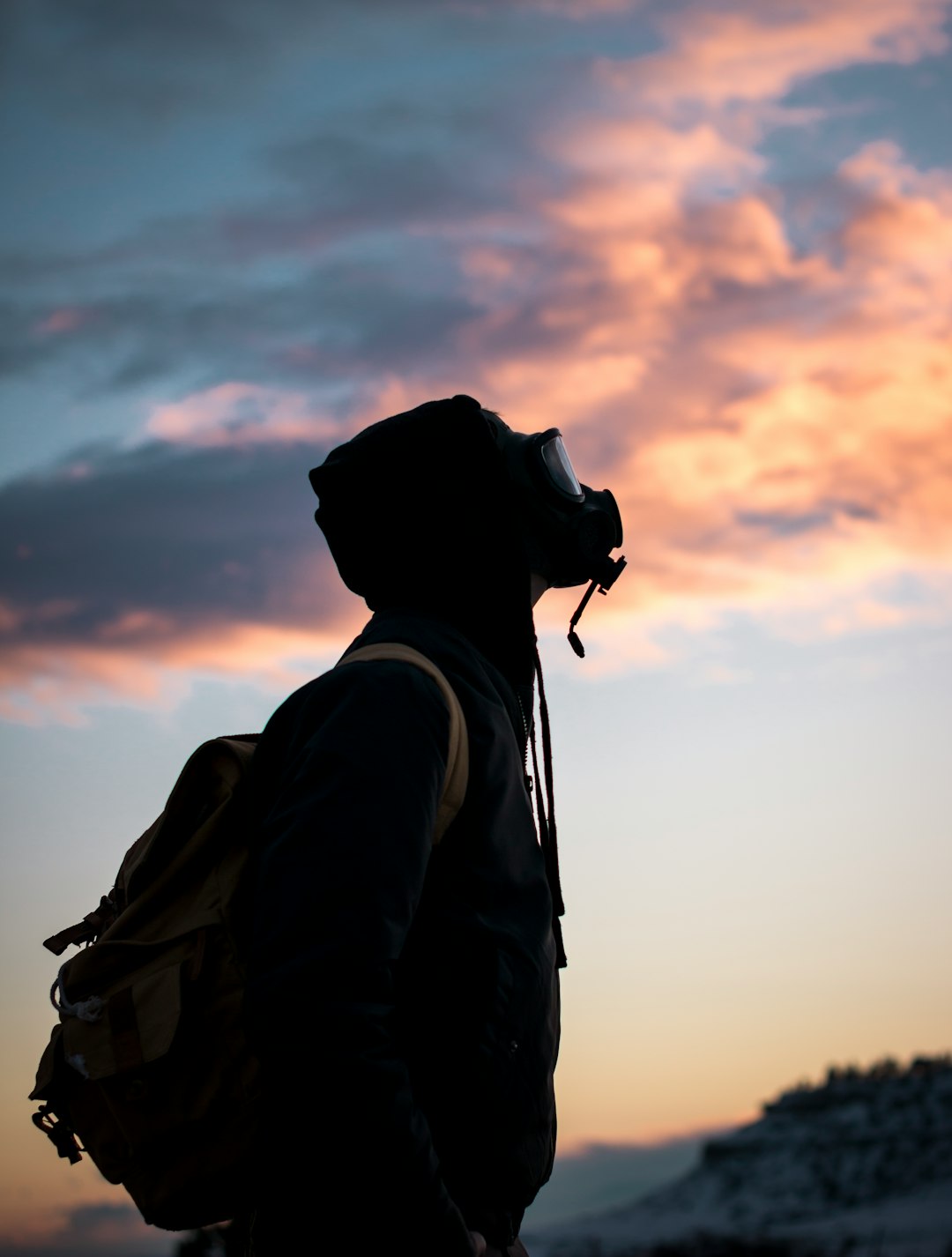 person wearing gas mask while looking up