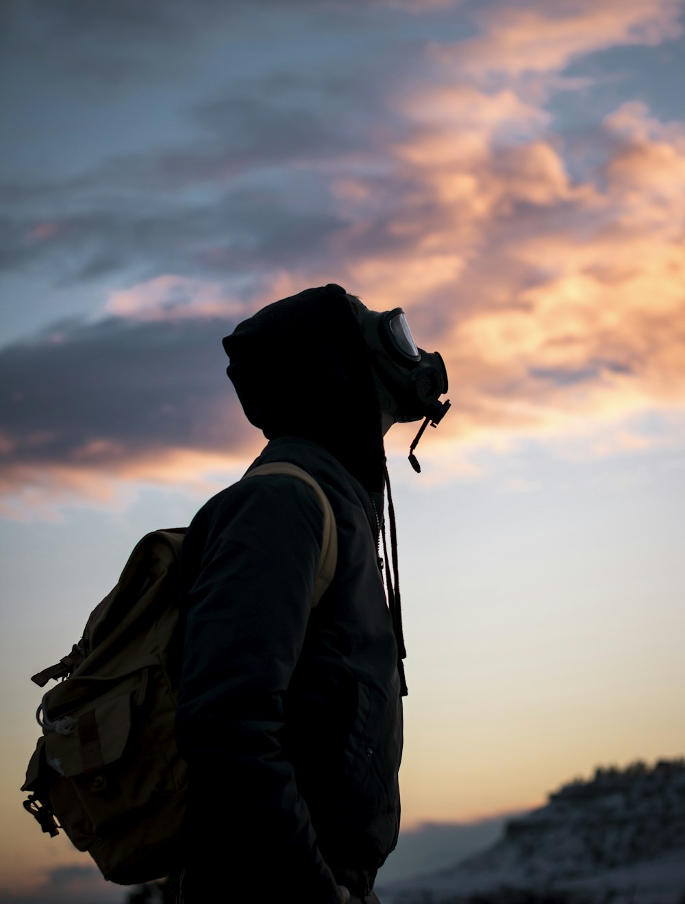 person wearing gas mask while looking up photo Free 