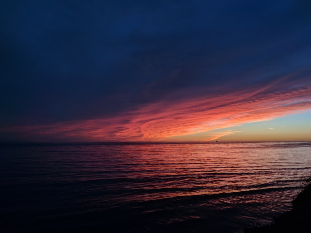 body of water during sunset