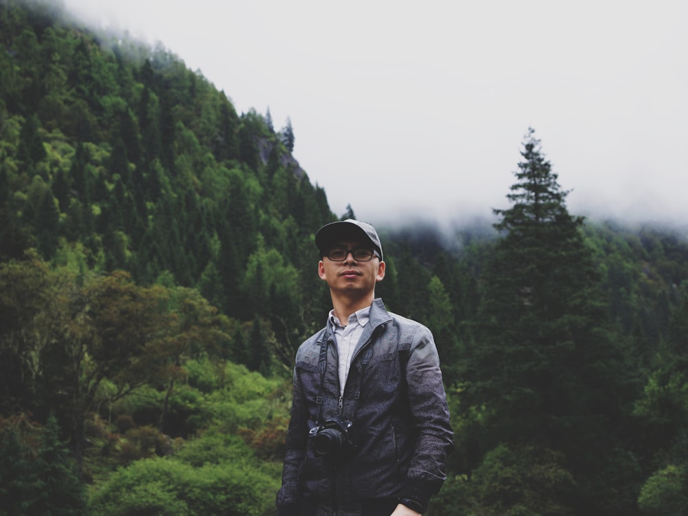 man standing near trees