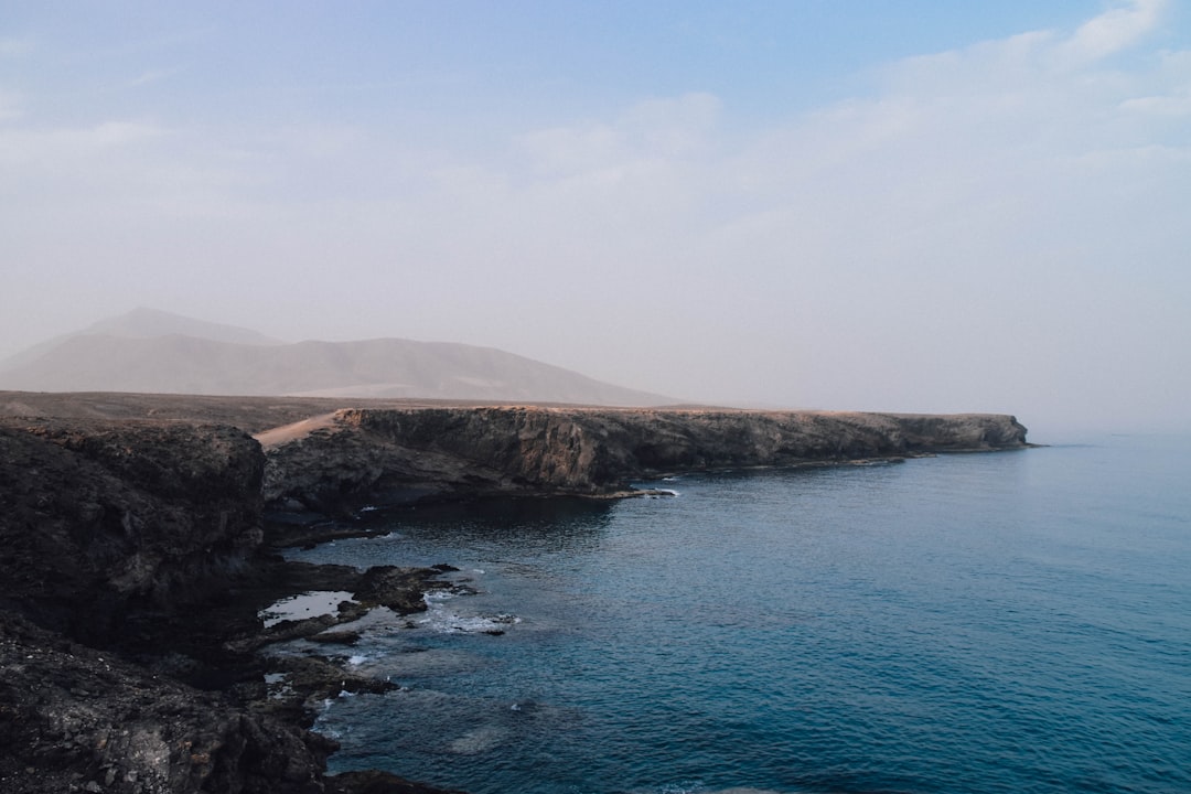 aerial photography of plateau by ocean cliff