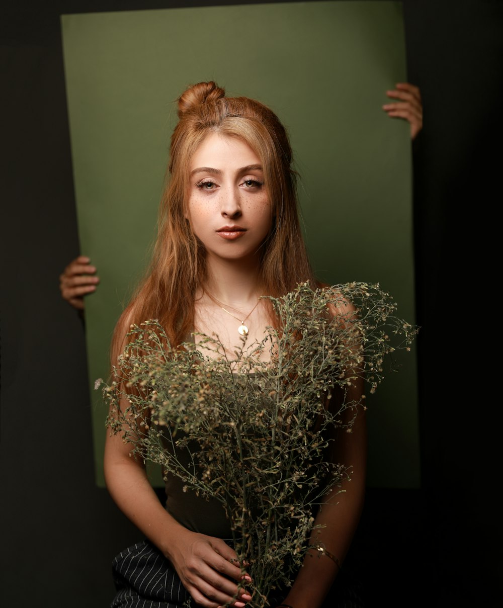 woman holding withered plants