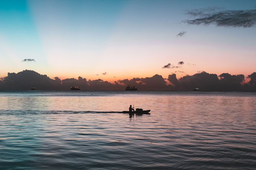 silhouette photo of person on boat