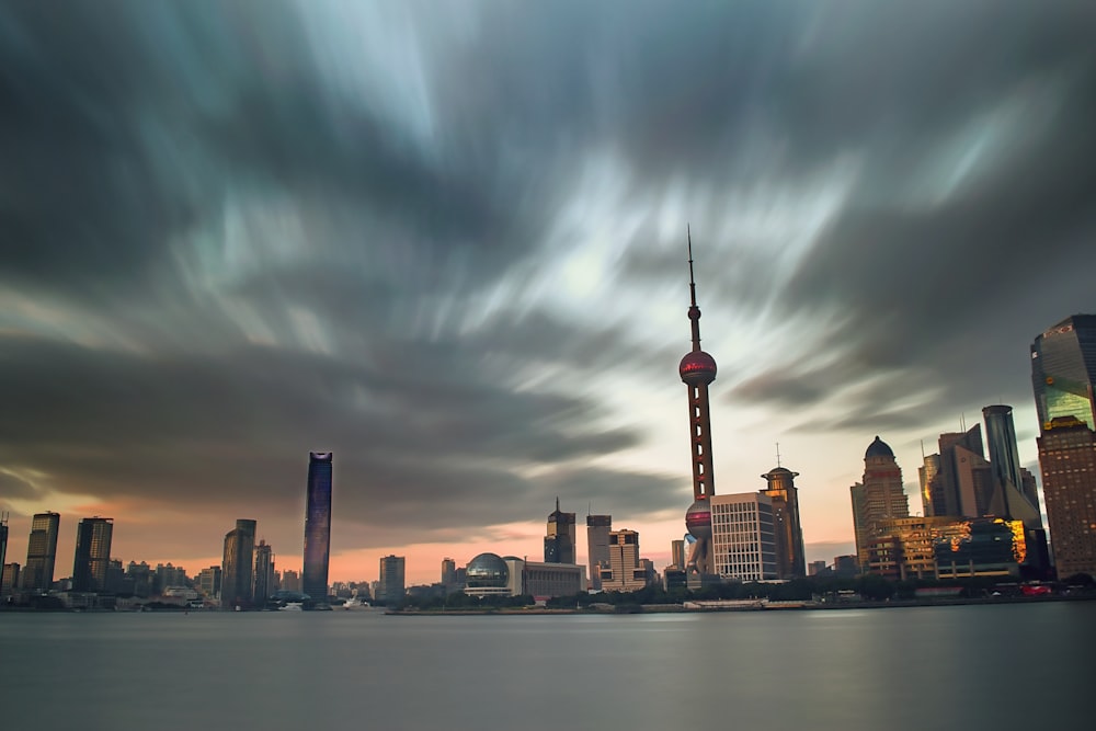 high rise buildings under cloudy sky