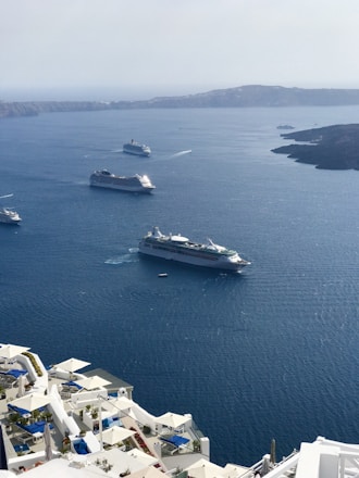 A scenic view of the Canary Islands with a cruise ship in the foreground.